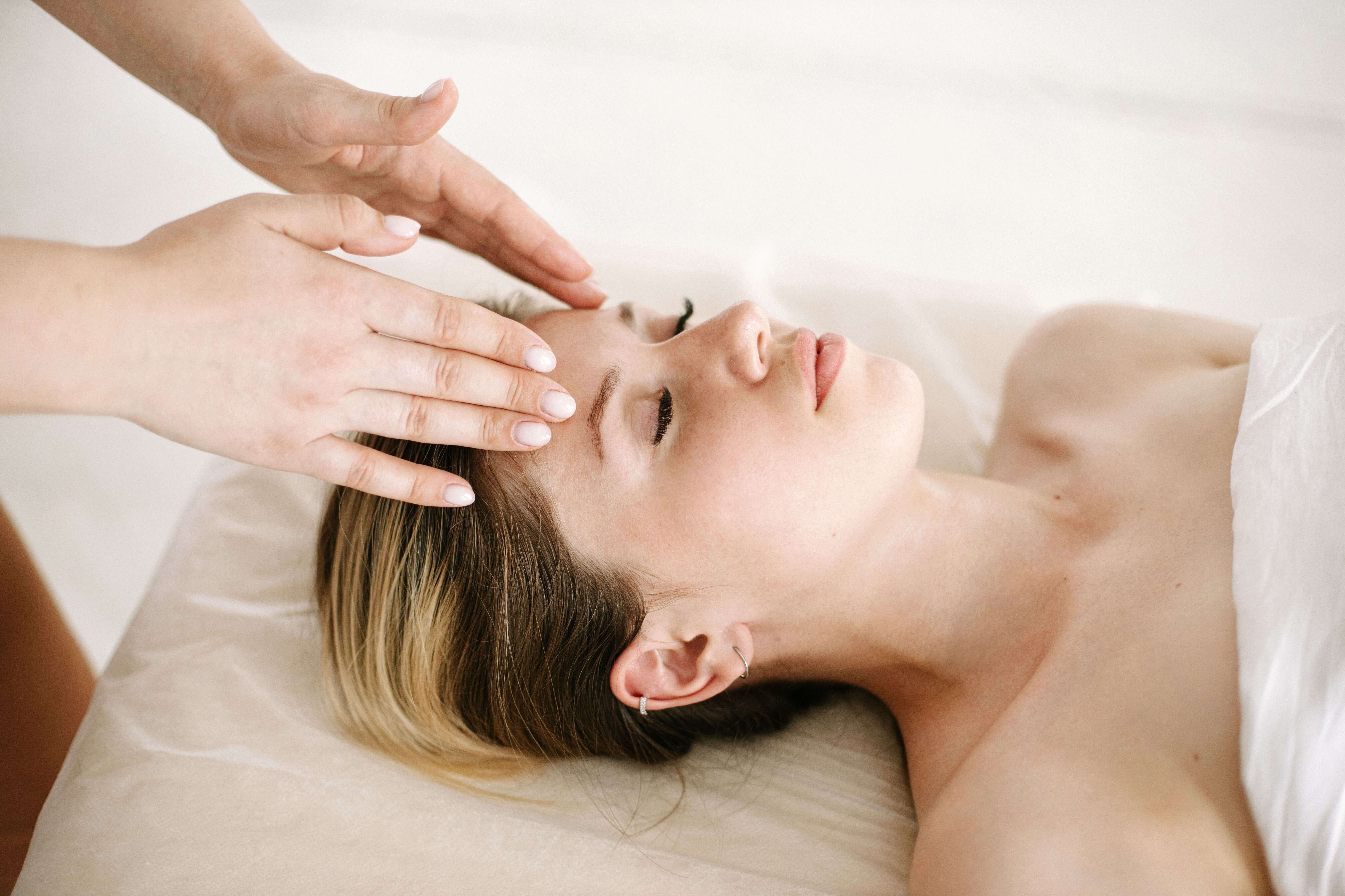 Woman relaxing with her eyes closed during a head and shoulder massage