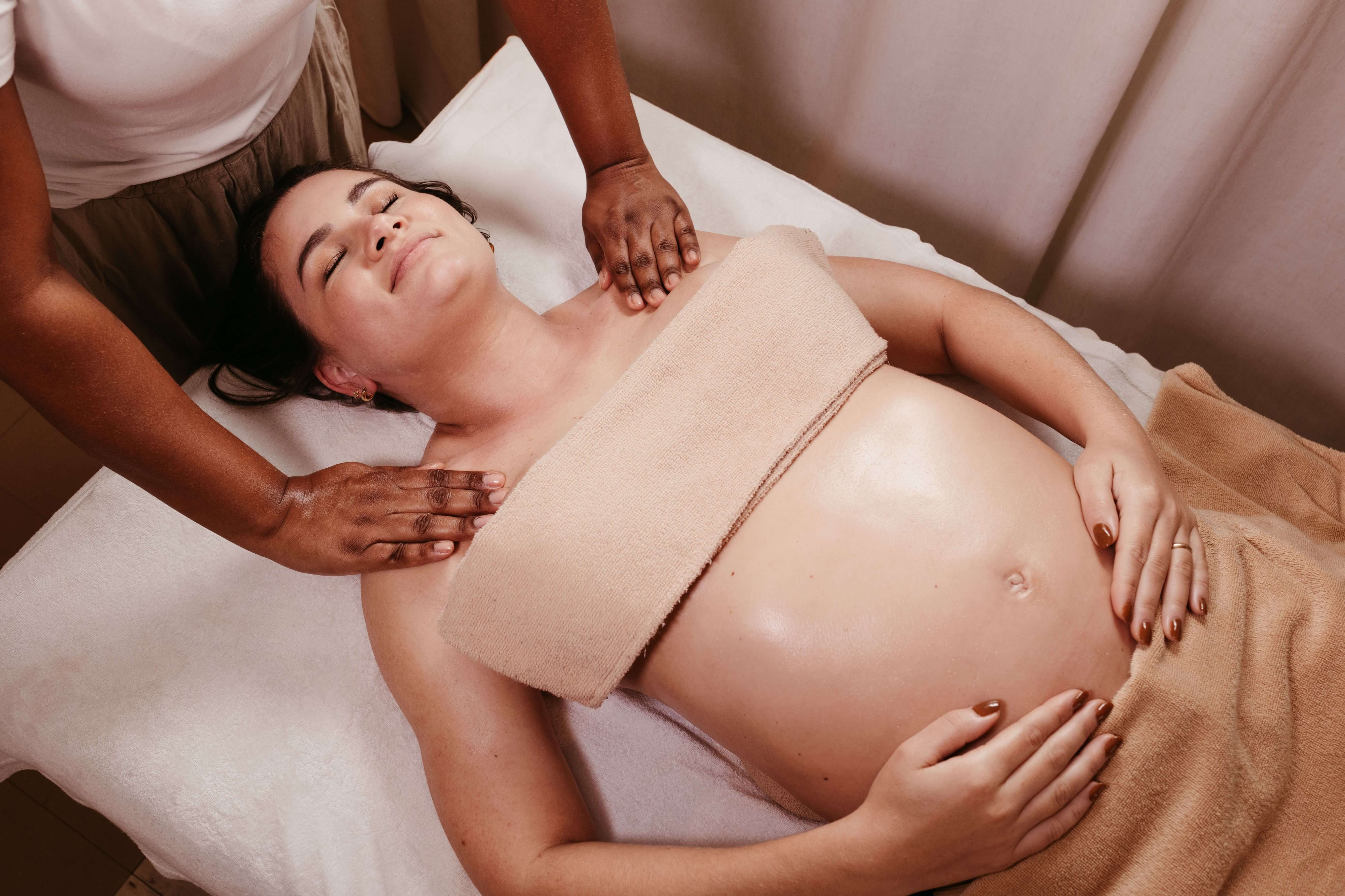Gentle massage of the lower back while the client rests on her side