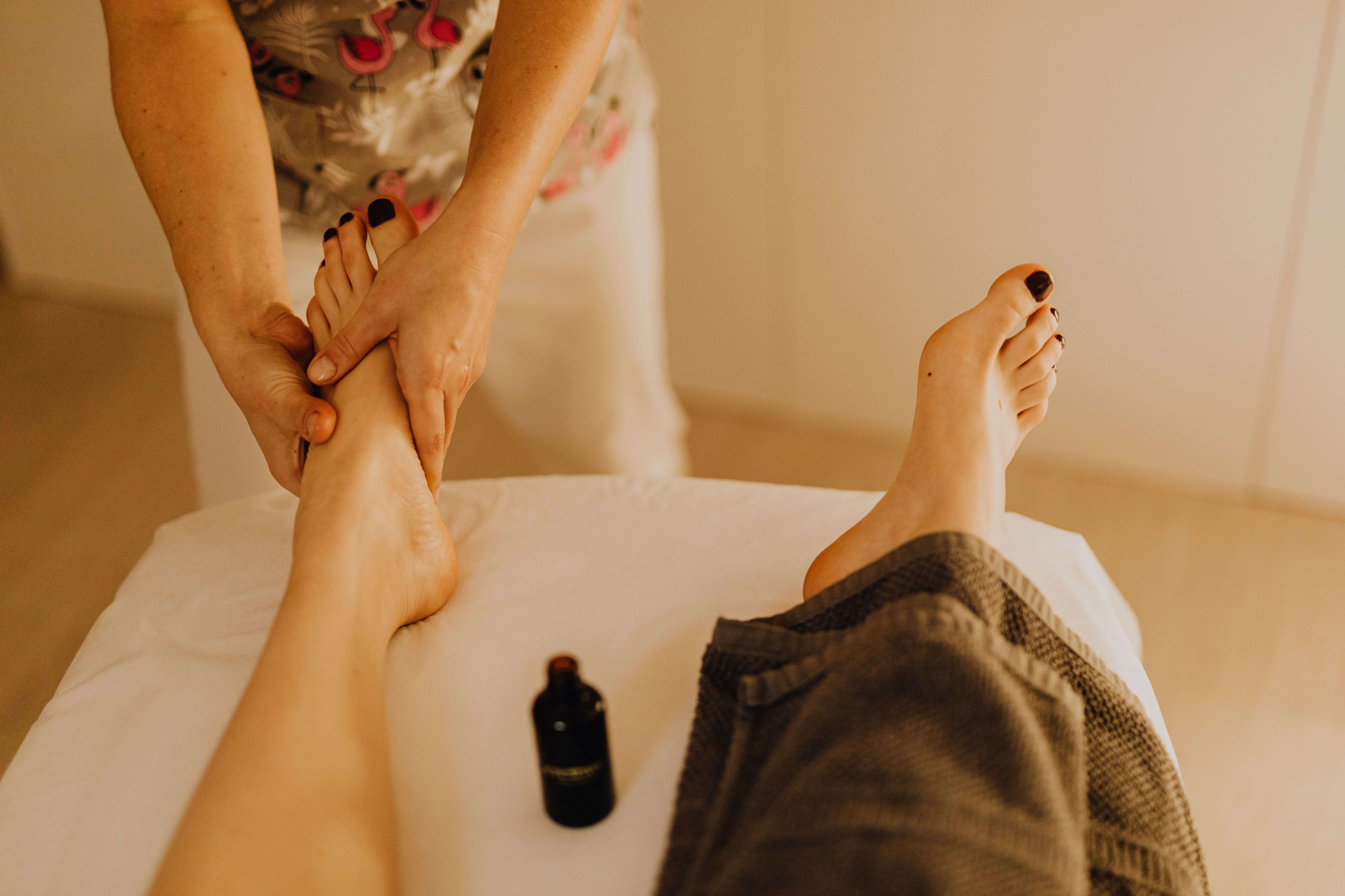 Therapist massaging the calf of a runner lying face down during a sports massage