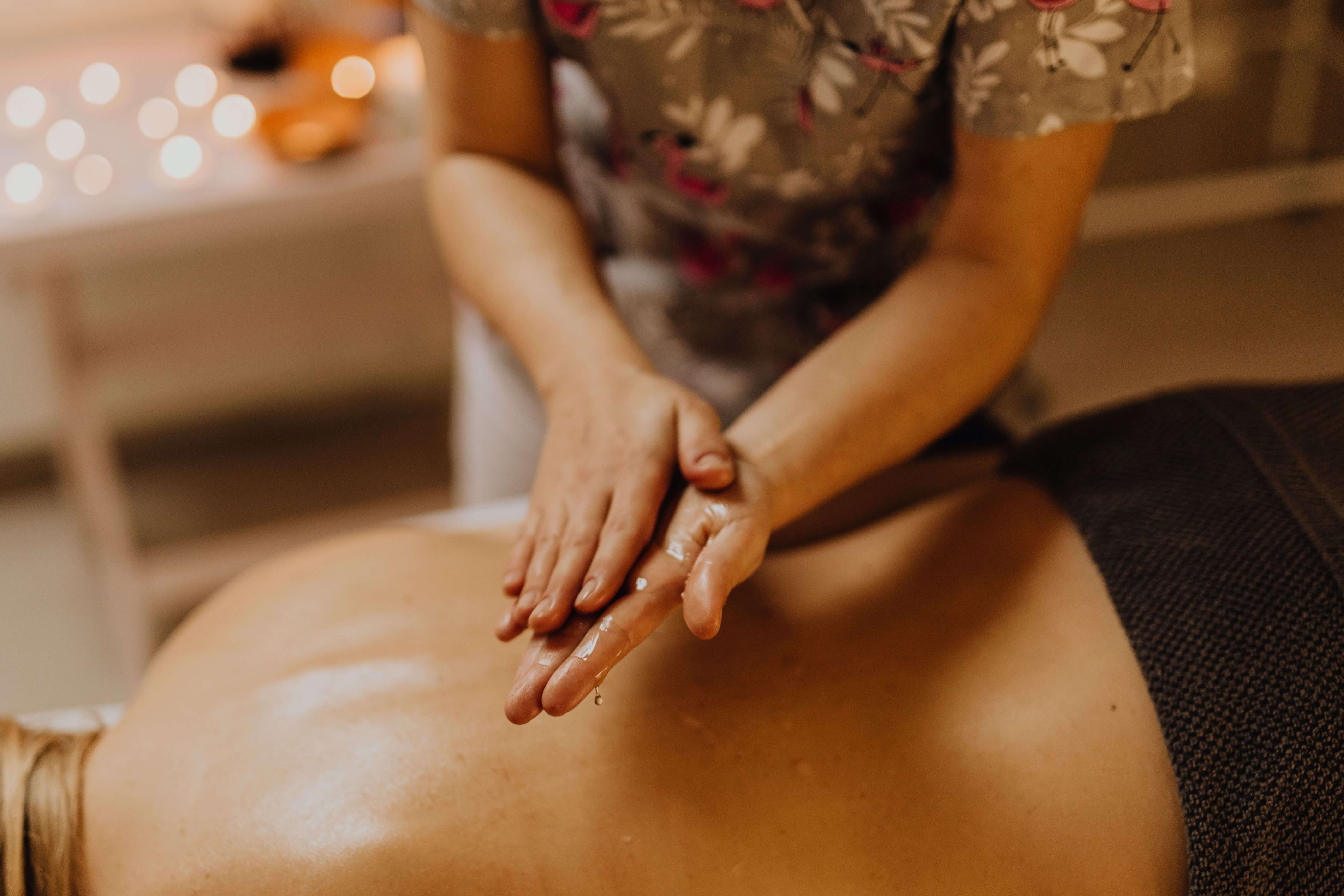 Long gliding strokes across the back during a Swedish full body massage